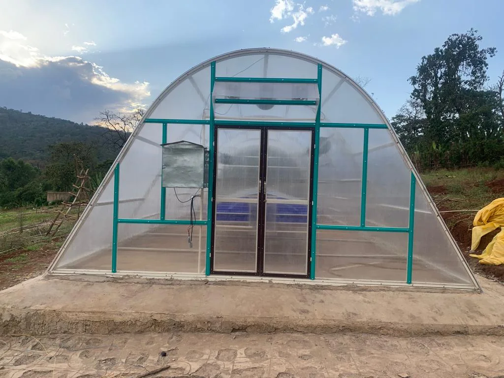 The polycarbonate drying unit from outside, a walk-in solar greenhouse with double doors